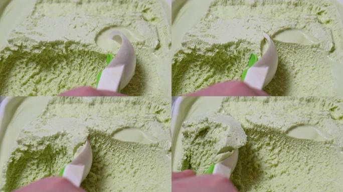 冰淇淋勺子。特写制作一勺开心果冰淇淋