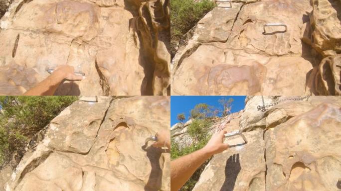 南非男子用梯级攀登阳光充足的岩石