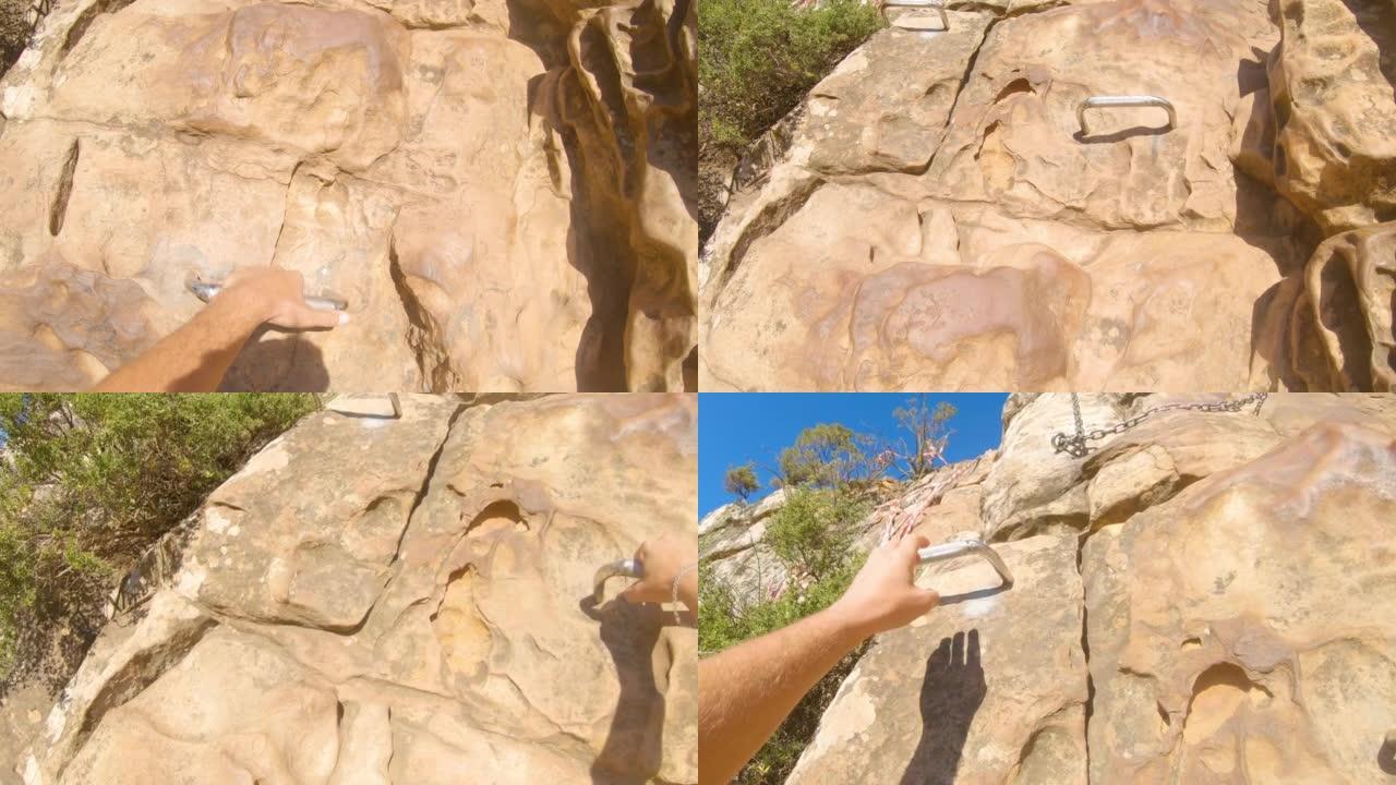 南非男子用梯级攀登阳光充足的岩石