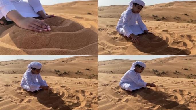 Emarati儿童在沙漠中玩沙子