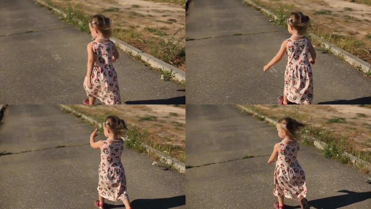 夏天的一天，两岁的女孩在公园的跑道上跑步