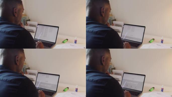 一个英俊的成熟商人在家庭办公室的笔记本电脑上工作的4k视频片段