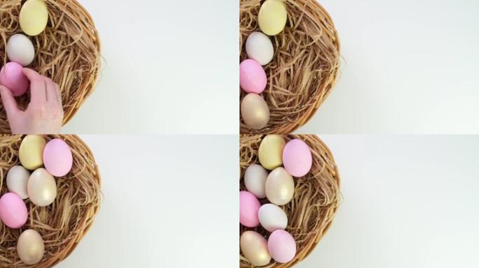 复活节。在篮子里的白色背景上画复活节的鸡蛋。复活节彩蛋装饰。如何组装节日篮子。假期的兔子。