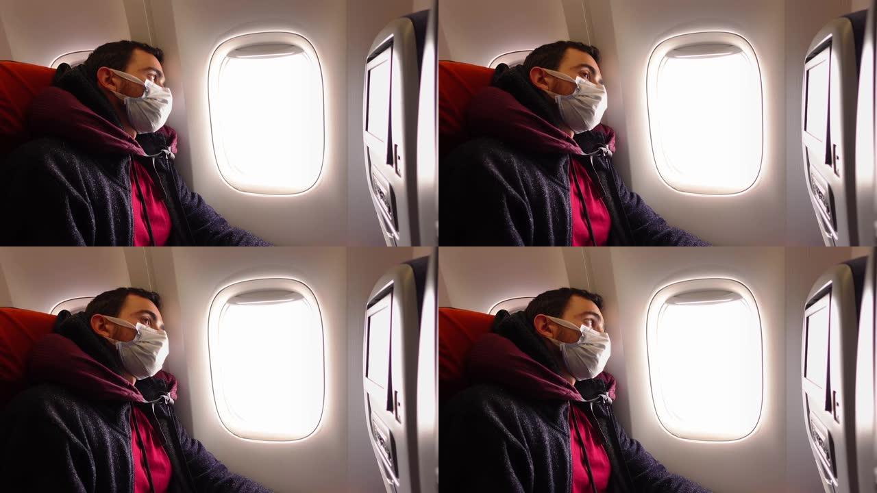 坐在飞机沙龙里戴着面膜的男人在叹气，透过窗户看
