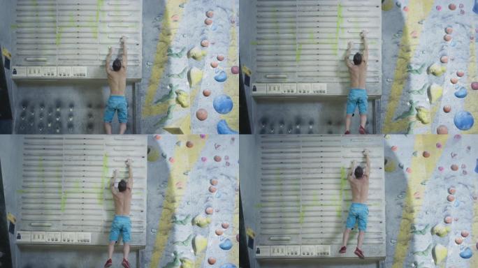 一个运动的人爬上指板来模拟攀岩。积极的生活方式，极限运动抱石。手指训练用攀岩设备