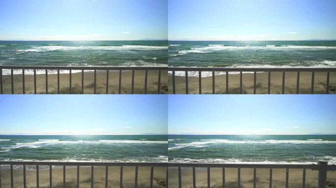 沙滩和栅栏外的海浪