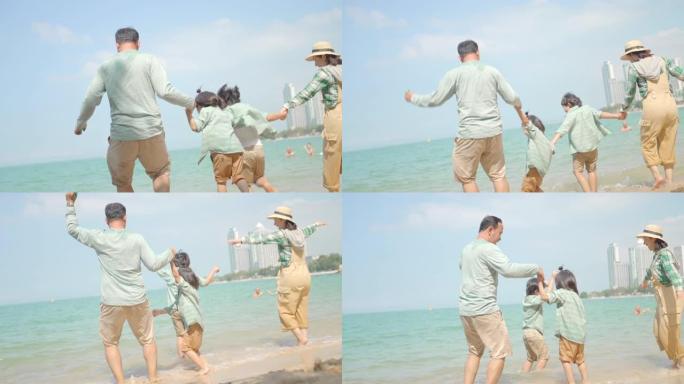 快乐的亚洲家庭，父亲母亲和可爱的儿子在一起，在夏天的阳光下奔跑进入美丽的海滩，在度假活动中尽情享受。