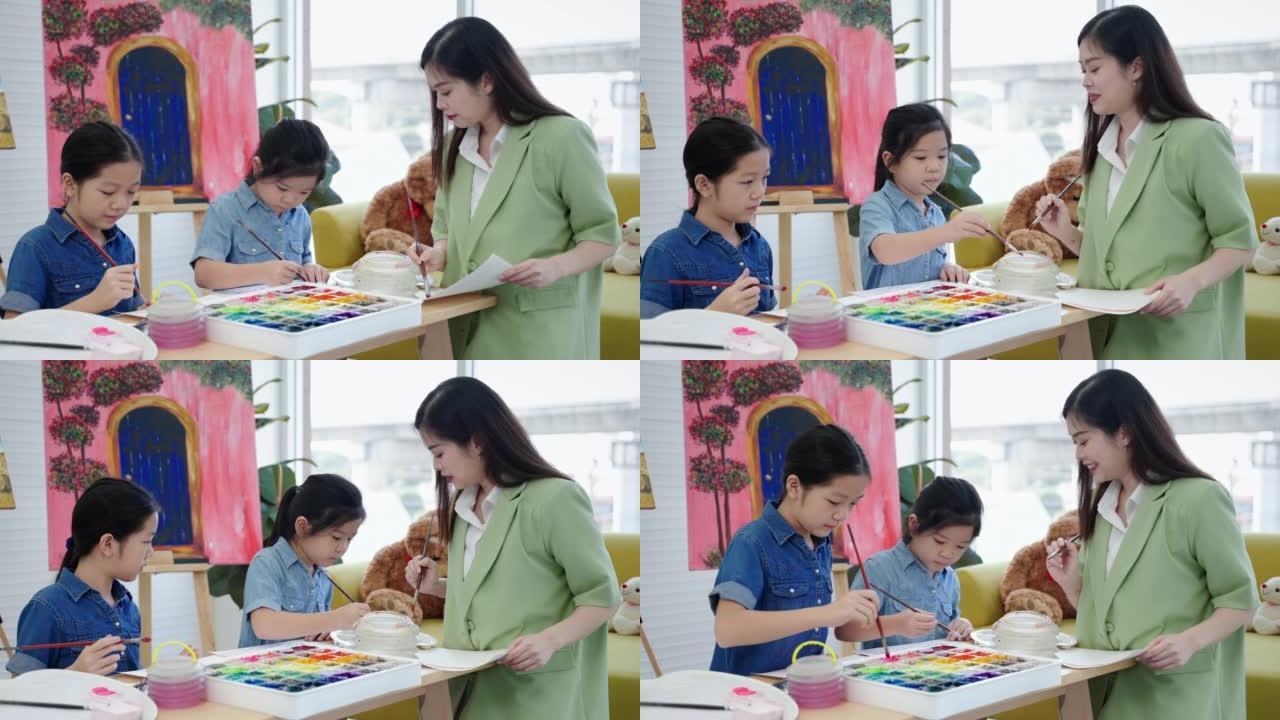 在一所艺术学校里，一位美丽的亚洲老师正在绘画课上教孩子们，教育的概念。