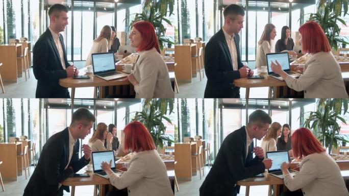 年轻的同事在午休时间在咖啡吧里讨论一个启动项目