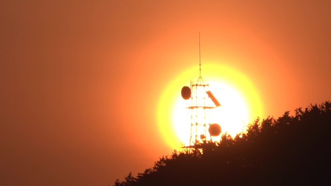 刺眼的大太阳从信号塔后面升起来了