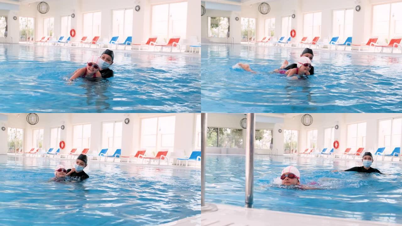 带面部医用防护面罩的水中女教练，在游泳池室内游泳池给孩子上游泳课