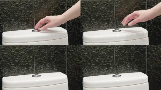 手按下马桶上的冲洗按钮。节水。卫生概念。