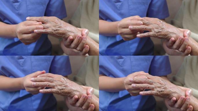 护理人员按摩痛风肿胀的老年妇女的手指。