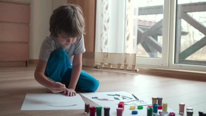 从事抽象画的才华横溢的艺术家儿童肖像使用画笔。小男孩在家画画。儿童创造力启发想象力。可爱的男孩孩子喜