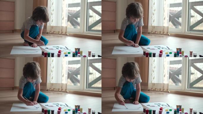 从事抽象画的才华横溢的艺术家儿童肖像使用画笔。小男孩在家画画。儿童创造力启发想象力。可爱的男孩孩子喜