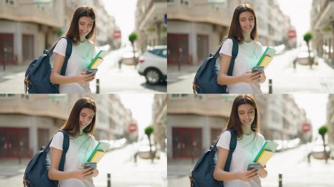 年轻的西班牙裔女学生在街上使用智能手机微笑着自信