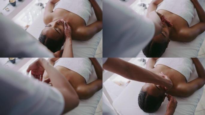 4k视频片段，一位迷人的年轻女子躺下并在水疗中心享受按摩