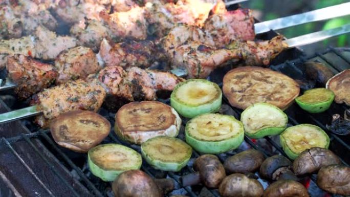 烤肉串在户外用金属串蔬菜烹饪。传统的东方菜肴腌制烧烤肉在木炭和火焰上烧烤炉上煮熟。烤猪肉、羊肉、烤肉