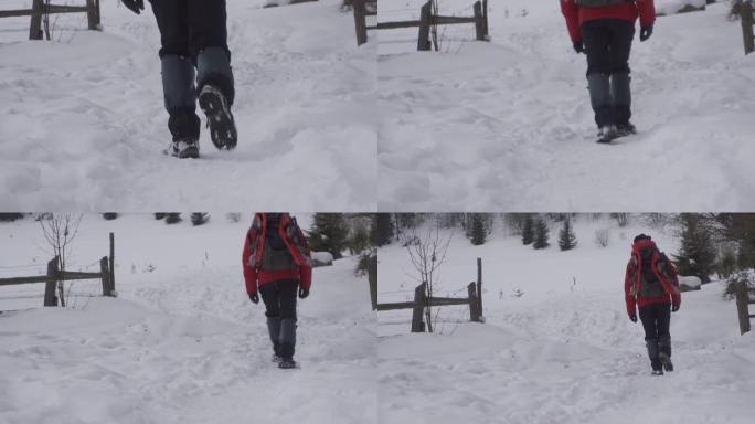 冬天的男人脚温暖舒适的鞋子在冬天的公园里的雪道上迈出一步。