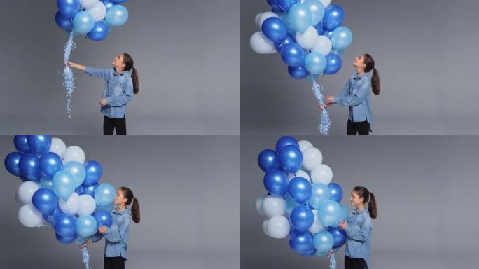 工作室用一堆蓝色气球射击女孩