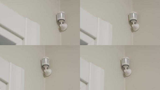智能家居无线运动传感器用于报警系统和智能家居自动化，小型塑料白色运动检测器安装在客厅。