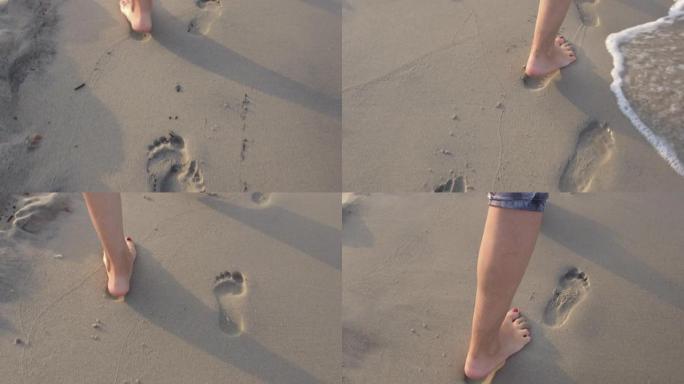 赤脚在沙滩上留下脚印，男人沿着海边散步。