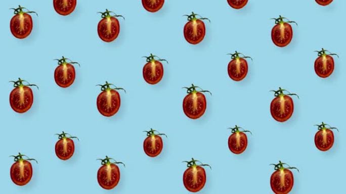 蓝色背景上新鲜红色西红柿的彩色图案。樱桃番茄切片无缝图案。逼真的动画。4k视频运动