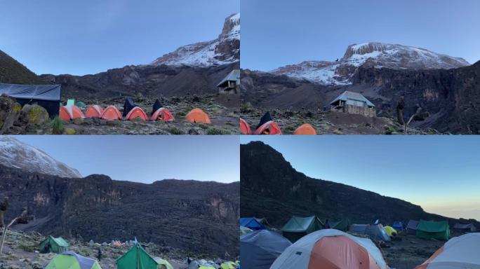 巴兰科营地。乞力马扎罗山、巴兰科墙和帐篷的壮丽景色。美丽的山景，游客和登山者。