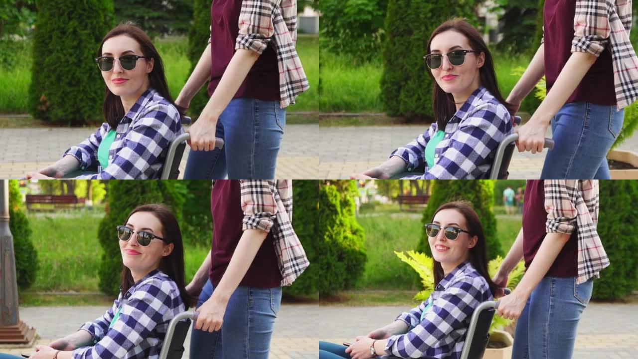 穿着衬衫的女孩卷着一个戴眼镜和穿着衬衫坐在轮椅上的残疾女孩。看着镜头