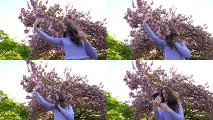 年轻女子对着日本樱桃树拍照