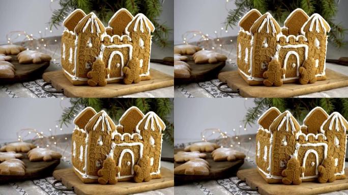 姜饼屋圣诞自制烘焙。姜饼人。圣诞树形状的饼干和桌子上的雪花。甜点的食物。冬季姜饼
