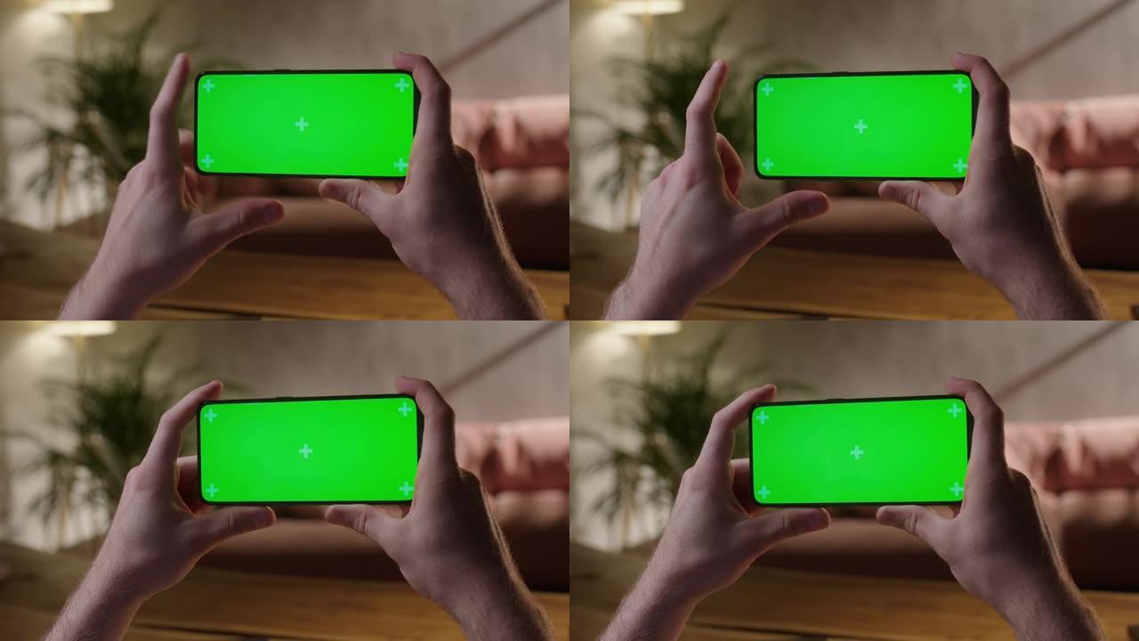 手持摄像头: 手机上的人的后视图，绿屏显示复印空间。没有跟踪标记的Chromakey模型。点击点击屏