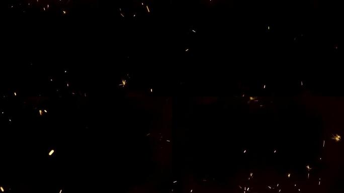 黑色背景上闪闪发光的孟加拉大火飞溅。黑暗中点亮烟火。闪闪发光的孟加拉烟花，带有金色的火花。假期，新年