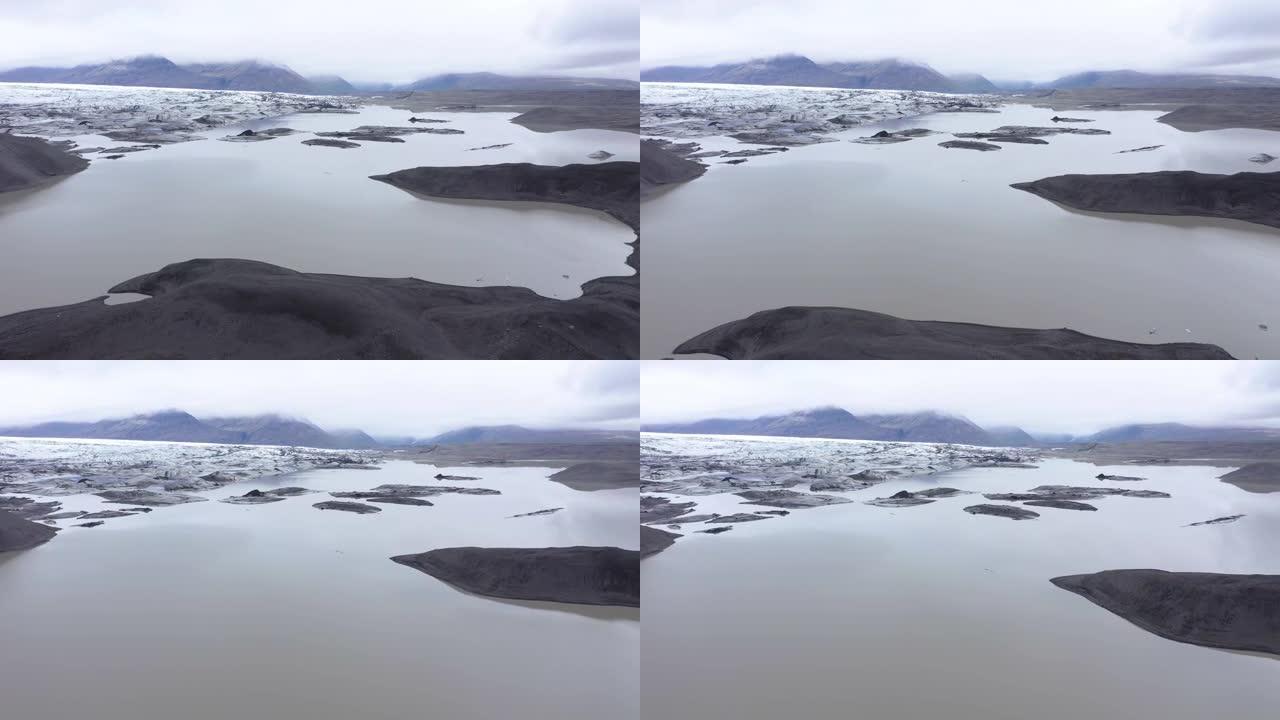 飞越冰岛Vatnajokull国家公园Svinafellsjokull湖融化的冰山。全球变暖和气候变