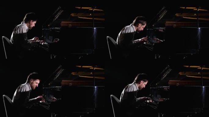 男人在黑色背景上弹钢琴。音乐家钢琴家在黑暗中表演，同时在音乐键盘乐器上表演经典爵士音乐会。特写。以5