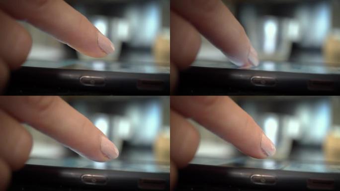 女人的手的特写，手指在带有触摸屏的智能手机上上下滚动，在网上冲浪，在Facebook或Instagr