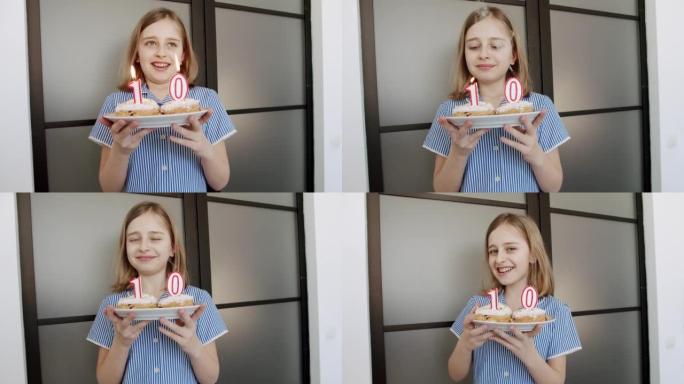 一个快乐可爱的10岁女孩的生日聚会，在蛋糕上吹蜡烛