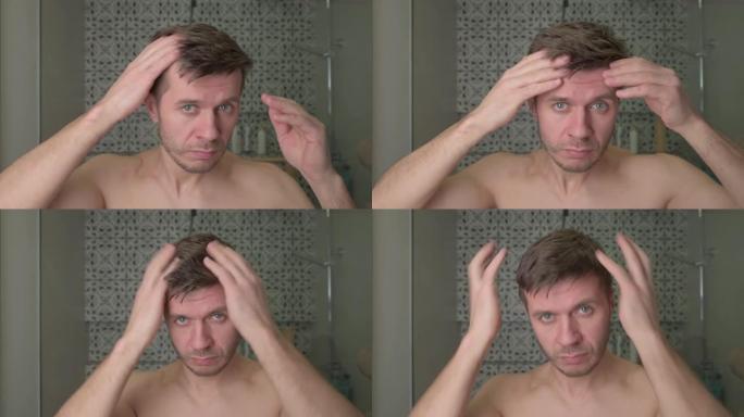 浴室里的男人看着他稀疏的头发