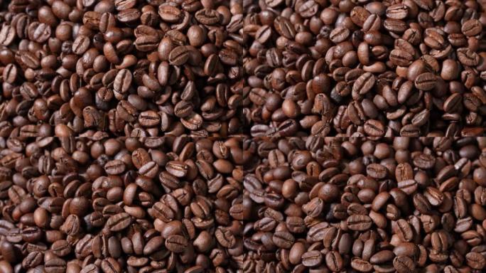 旋转堆烤咖啡豆。一大堆新鲜烘焙的浓郁芳香咖啡豆。慢动作。