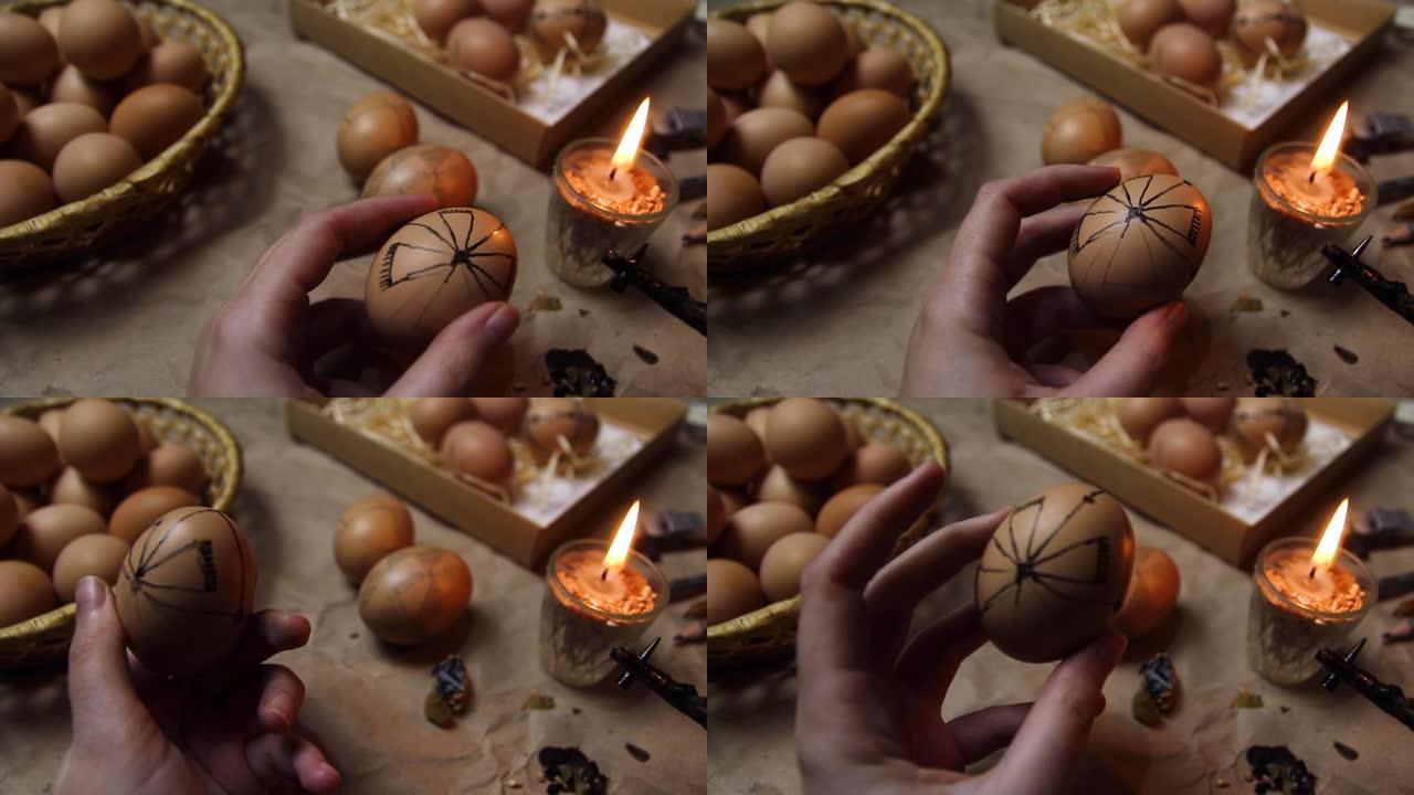 女性手持鸡蛋和油漆皮桑卡。准备用抗蜡法绘画乌克兰复活节彩蛋，装饰有民间设计。复活节彩蛋。图形民间素描