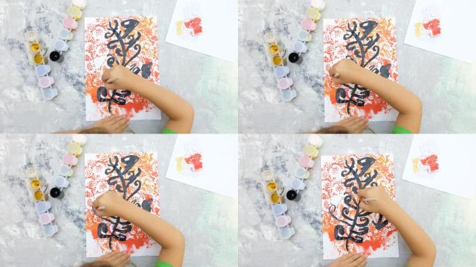 小女孩用水粉画花或树，儿童艺术。工艺品概念。如何制作贺卡，为母亲节或儿童生日制作手工礼物