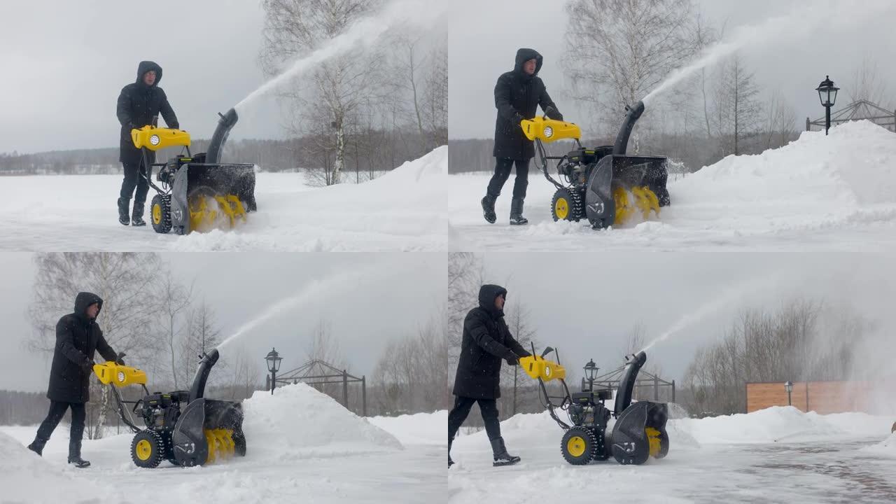 男子在庭院用机械扫雪机除雪。慢动作