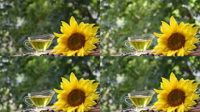 玻璃盘中的葵花籽油。用于制造油的葵花花和种子。选择性聚焦