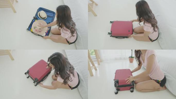 俯视图，亚洲妇女在家中卧室打包行李箱，为旅行做准备。准备行李和必需品，护照，为暑假制定旅行计划。旅行