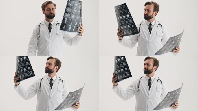 认真的男子医生用听诊器专心观察并比较两个x射线图像