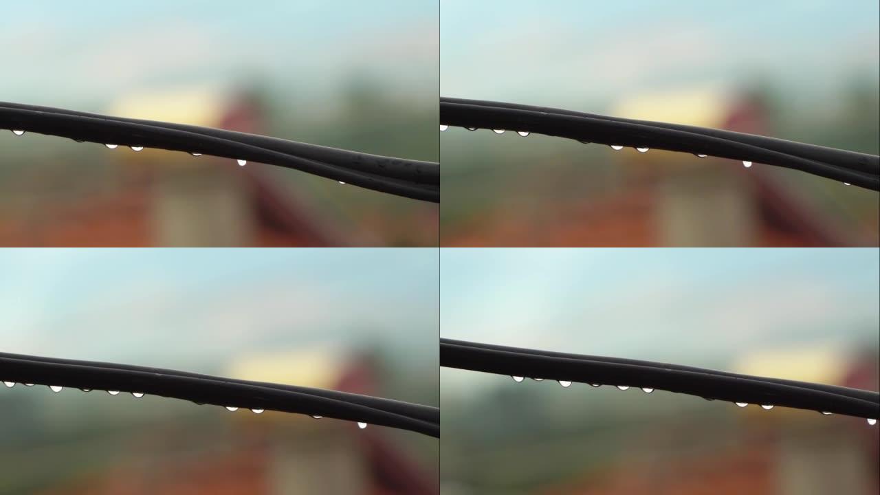 雨中电线上的清澈纯净水滴