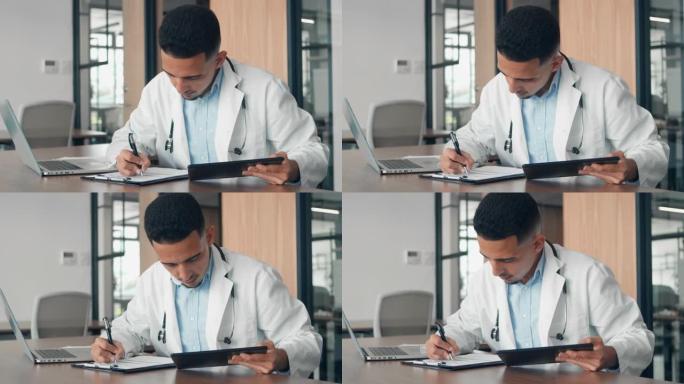男医生做笔记并使用他的平板电脑