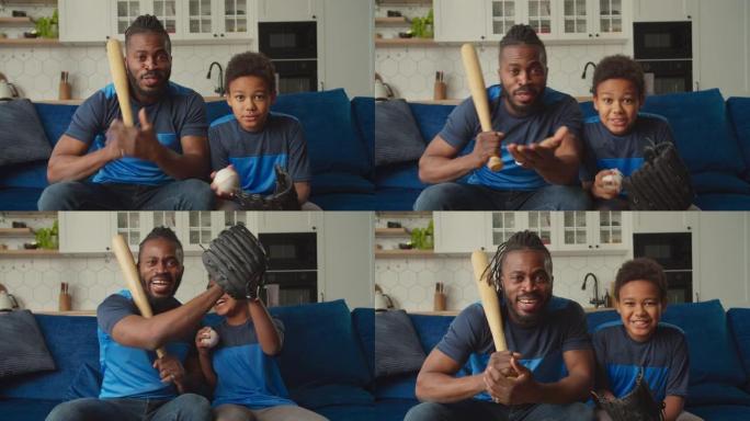 快乐的非洲裔美国儿子和父亲在家里的电视上观看棒球比赛