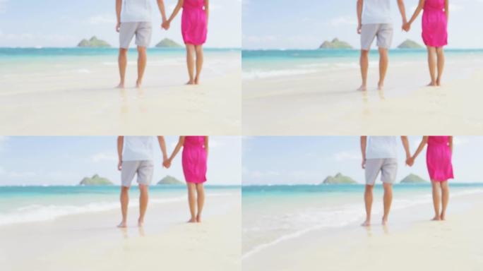 海滩上牵着浪漫的新婚夫妇。背景不集中和模糊。在美国夏威夷瓦胡岛的Lanikai海滩上，女人和男人在暑