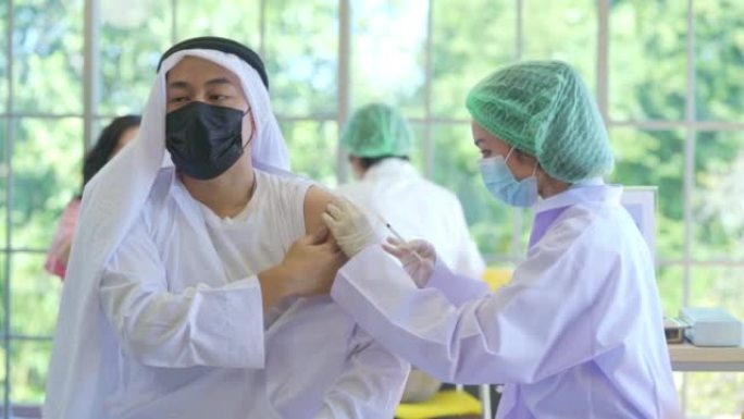 医生在医院给一名中东阿拉伯男子注射新冠病毒疫苗，以预防欧米克隆冠状病毒的爆发